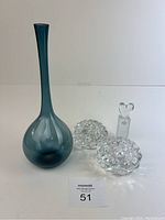 Full lot showing the blue blomvase and the three clear glass items placed beside it, on a white surface.