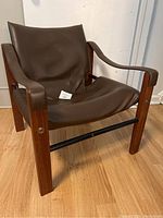 Three-quarter front view of the chair showing overall form, upholstery and frame.