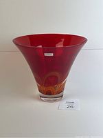 Front view of red crystal Waterford Evolution vase with original sticker, showing flared shape and clear base with orange swirl detail inside.
