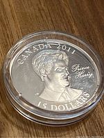 Reverse side of the coin showing Prince Harry portrait, Canada 2011 and 15 dollars denomination.