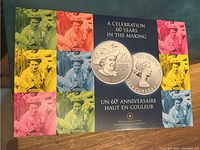 Front and back cover of the certificate and display packaging showing colorful collage with coin images and title 'A Celebration 60 Years In The Making'