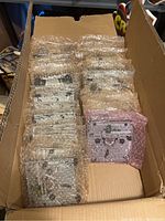 Box with multiple bubble-wrapped Wii DVD drive mechanisms