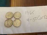 Four 1965 Canadian 50 cent coins showing the obverse side with Queen Elizabeth II.