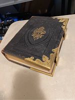 Front cover view showing embossed leather and brass corner mounts