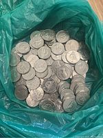 Bag full of vintage Canadian 5 cent coins with nickel finish, showing obverse and reverse sides including beaver design.