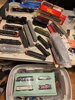 Overhead view showing multiple locomotives, freight cars, autorack car, and foam-packaged set