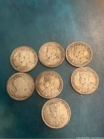Obverse of 7 Canadian 25 cents silver coins showing King George V profile and inscriptions.