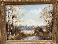 Front view of the small lake scene painting featuring white birch trees and a muted color palette in a decorative gold-painted frame.