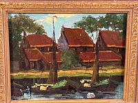Front view of the oil painting showing lakeside cottages, boats, and trees under an ornate gold frame