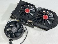 Top-down view of XFX Radeon RX 590 graphics card and AMD fan showing fans and overall condition