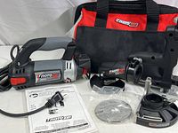 Corded Roto Zip RZ20 rotary cutter alongside accessories and carry bag, showing overall lot contents.
