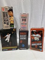 Overall view of the five San Francisco Giants collectible bobbleheads in their original packaging, showing front of boxes and clear identification of characters.