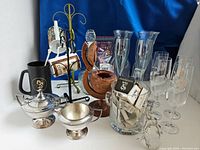 Full lot showing the beetle bottle opener, crystal flutes, mugs, cup racks, decanter, silverplate creamer and sugar bowl, and wood ashtray