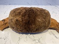 Top view of vintage sheared beaver fur muff showing dense plush fur texture in rich brown color.