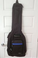 Front view of the Voyager soft carry guitar case showing main body and front zipper pocket with blue strip.