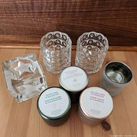 Photo showing all holders and candle tins arranged on a wooden surface