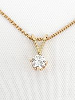 Close-up of diamond pendant and bail on gold chain