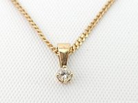 Close-up of pendant showing round brilliant diamond in six-prong setting