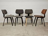 Front view of four bentwood chairs showing different upholstery styles and black bentwood frames.