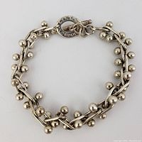 Full view of bracelet laid flat showing overall design and closure