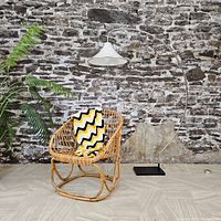Full view of chrome arc floor lamp with white shade and black rectangular base against brick wall