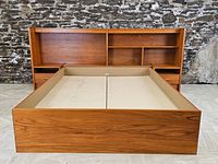 Full front view of queen bed frame including headboard, shelves, nightstands, and side rails laid out