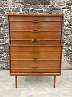 Front view of highboy dresser showing six drawers and tapered legs
