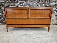 Front view showing two upper drawers and one lower drawer with recessed pulls