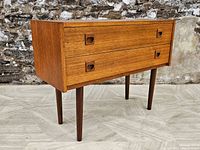 Front-and-left angle view showing overall case, drawers and legs