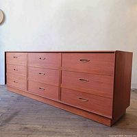 Angled front-left view showing all nine drawers and base