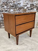 Front and side view of walnut nightstand showing two drawers and tapered legs