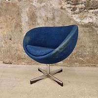 Front view of blue upholstered Planet Chair swivel seat on metal and wood base