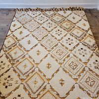 Top-down view of full rug laid on wooden floor showing overall diamond geometric pattern