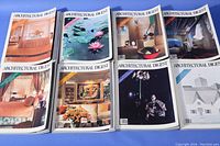 Eight Architectural Digest magazines with covers showing various interior and architectural design scenes, including rooms and artworks