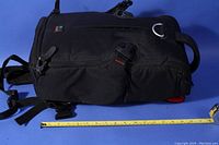 Side view of Kata 3N1-20 sling backpack camera bag with measuring tape showing approximate size