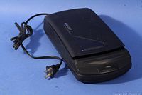 Closed Solidex VHS video cassette rewinder showing overall physical condition and cord.