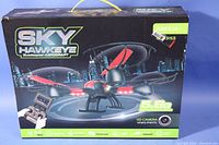 Front view of the original Sky Hawkeye drone box showing a black and red quadcopter drone, remote controller with LCD screen, and branding details.