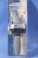 Front view of Mastercraft Maximum Drywall Axe in original packaging showing the die-cast blade area and rubber handle.