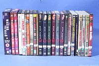 Photo showing a horizontal lineup of 20 DVD sets primarily of crime drama shows and some movies, titles clearly visible including Waking the Dead series 8 and two series 9 sets, Prime Suspect 1 through 7, and others.