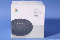 Front view of the Google Home Mini box showing speaker image and branding.