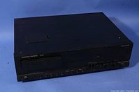 Front left angled view showing the full unit, buttons, and control dials on the front panel.