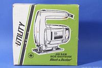 Original box with green and white design featuring an illustration of the jig saw and product name.