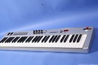 Full view of the M-Audio Radium Midiman MIDI keyboard with black and white keys, control knobs, sliders, and digital display.