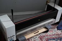 Full view of the Agfa APL 32 laminator showing metal housing, control levers, and feed area.