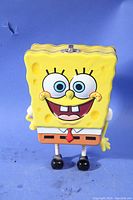 Front view of SpongeBob SquarePants lunch box showing facial details and legs.