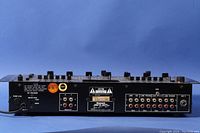 Back panel showing power input, caution labels, and input/output RCA and microphone jacks.