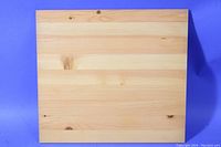 Top view of a pine shelf showing natural wood grain and knots on a tabletop.