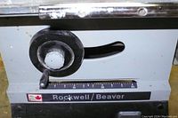 Close-up of Rockwell Beaver branding and adjustment dial on saw base.