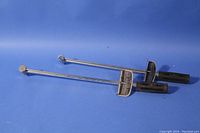 Two torque wrenches laid flat on a blue surface, showing their length, handles, and torque scales