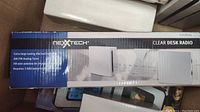 Side view of the boxed NexxTech Clear Desk Radio showing product branding and features.